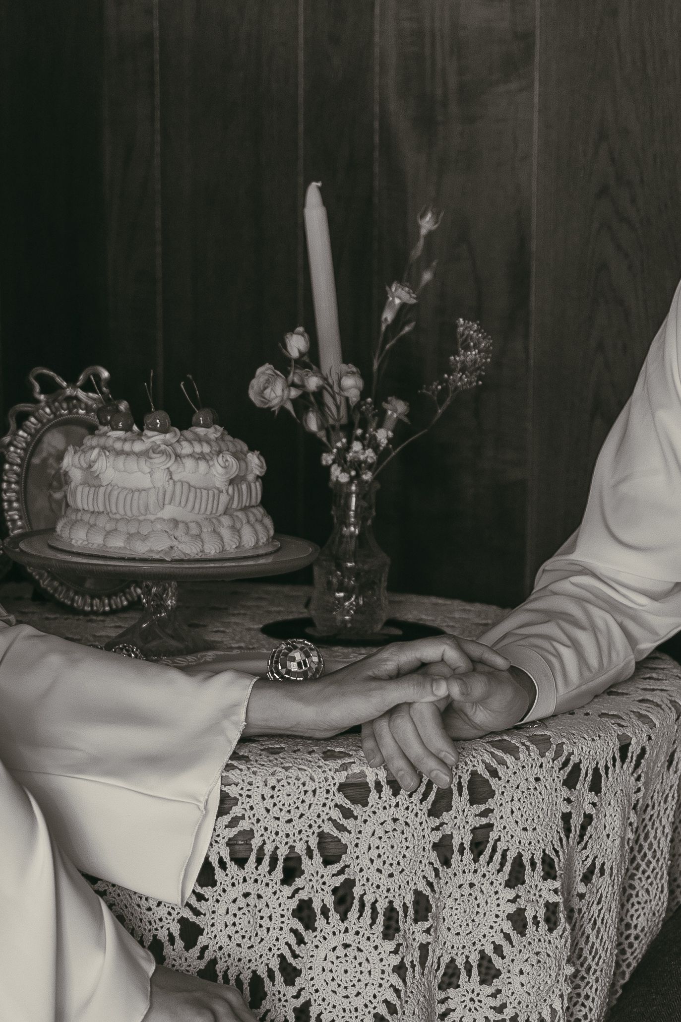 Intimate detail of hands holding at elopement in Akron Ohio with their cake by Gypsy Lens Photography. Moody, vintage, nostalgic, candid.