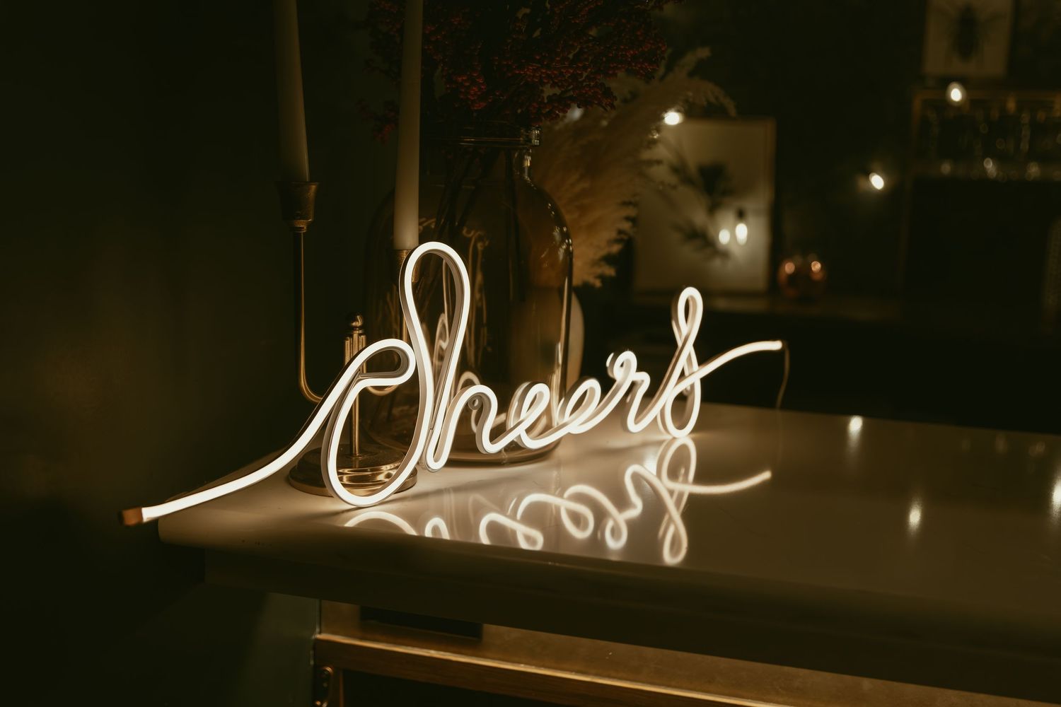 Glowing neon sign in speakeasy bar in Cleveland Ohio by Gypsy Lens Photography. Moody, filmy, vintage, documentary wedding photography.