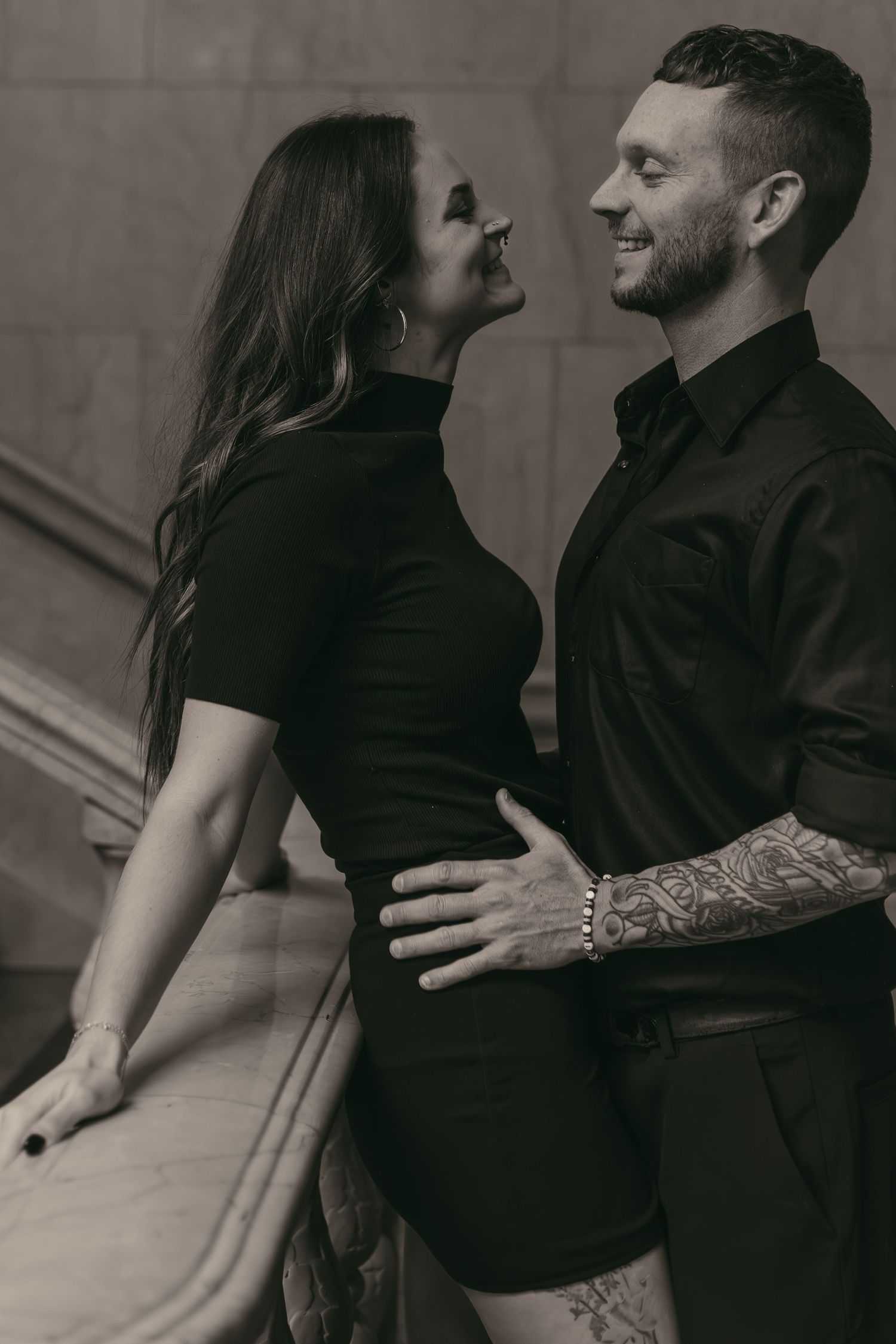 Engaged couple smiling at library in Cleveland Ohio by Gypsy Lens Photography. Moody, filmy, vintage, documentary wedding photography