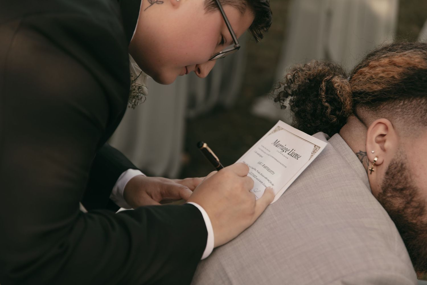 Brides signing marriage license in Cleveland Ohio by Gypsy Lens Photography. Moody, vintage, documentary wedding photography.