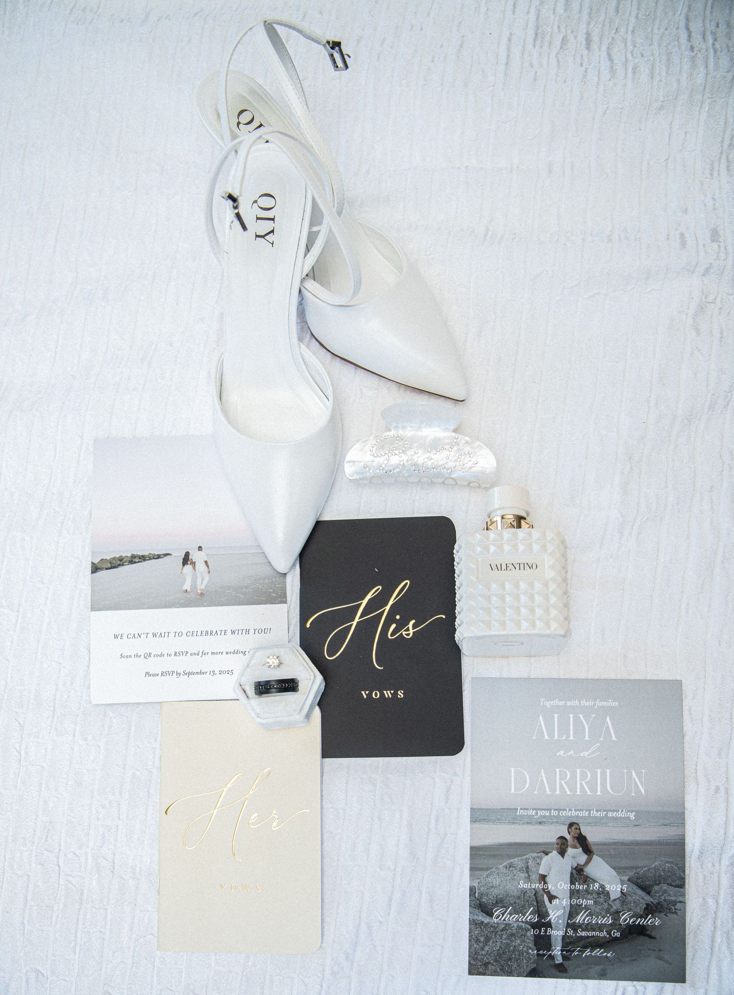 Wedding stationery flat lay with black and white cards and engagement photo.