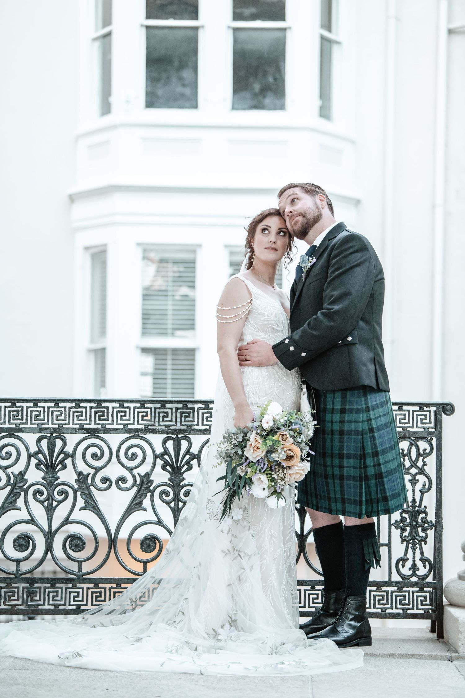 Intimate wedding portraits with Scottish groom and bride against classic architecture.