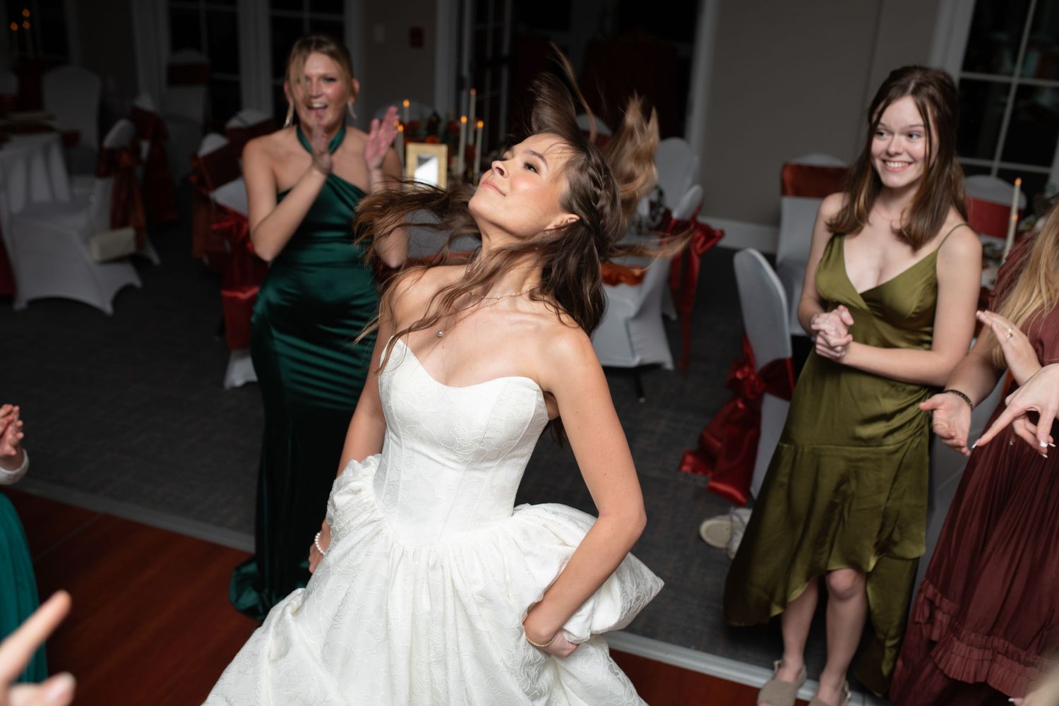 Wedding guests dancing and enjoying themselves at an evening reception.