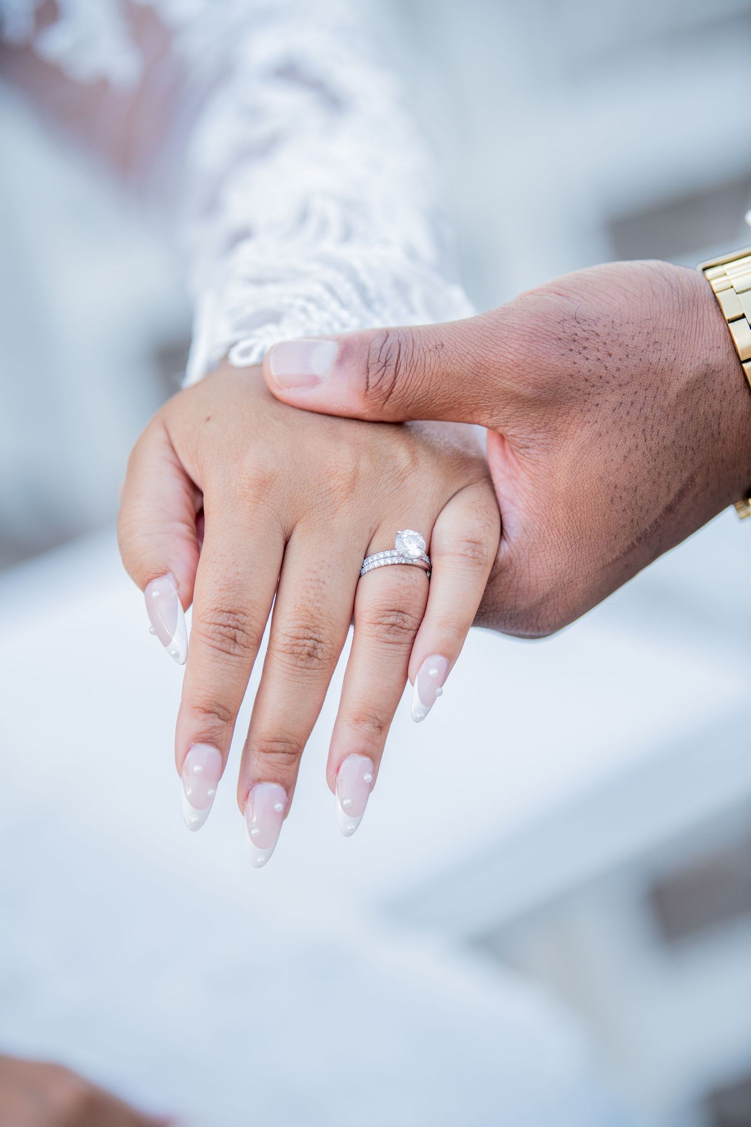 Close-up photographs of wedding rings and manicured hands showing matrimonial jewelry.