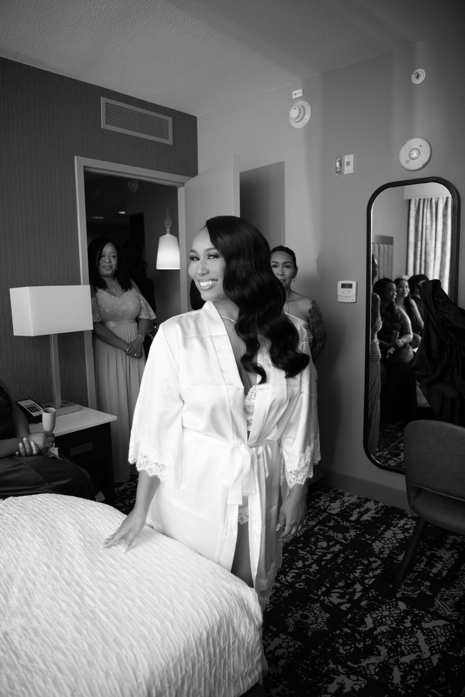 Getting ready scene showing a white silk robe and hotel room preparations before a wedding ceremony.