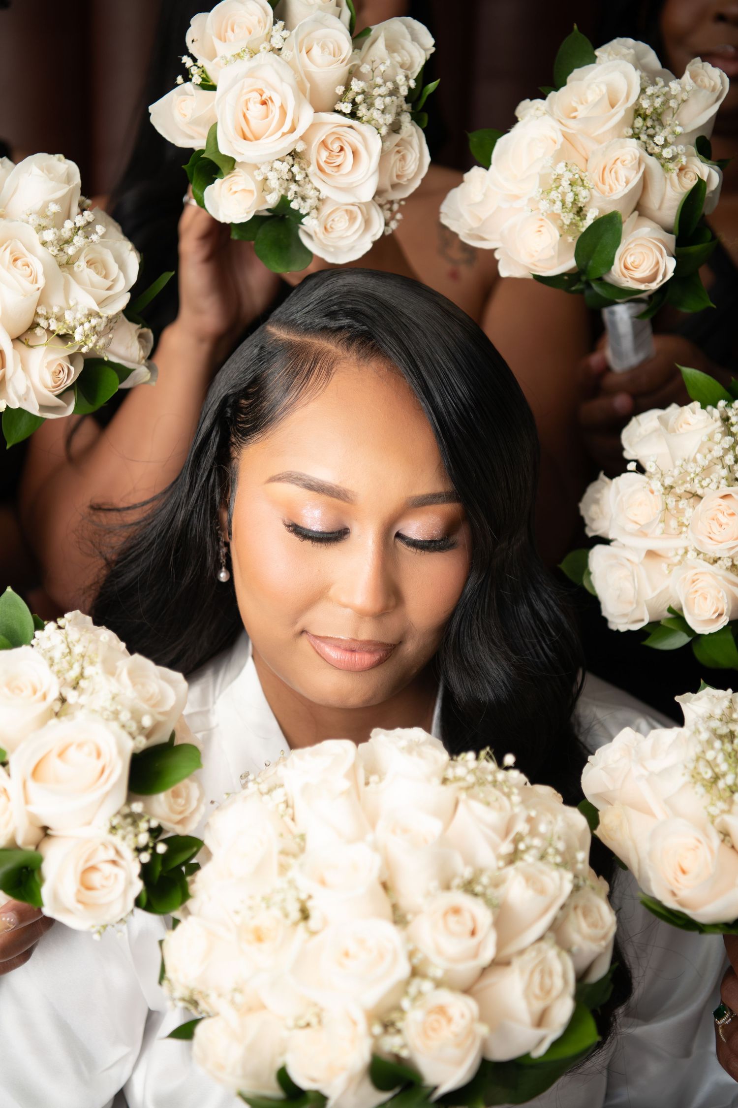 Delicate white roses and baby's breath create a romantic bridal bouquet arrangement.