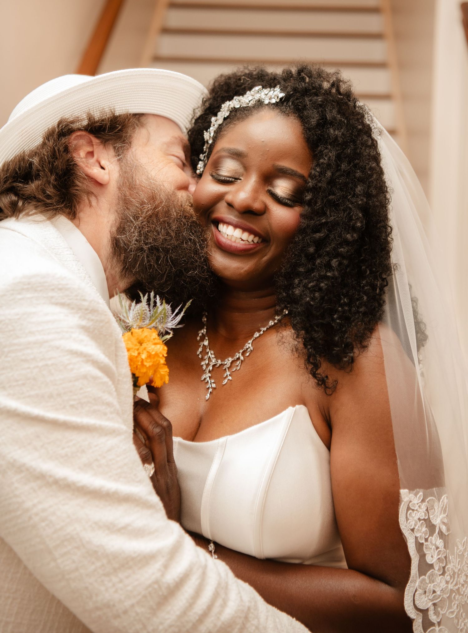 Close-up wedding photos capturing romantic moments between newlyweds in white attire.