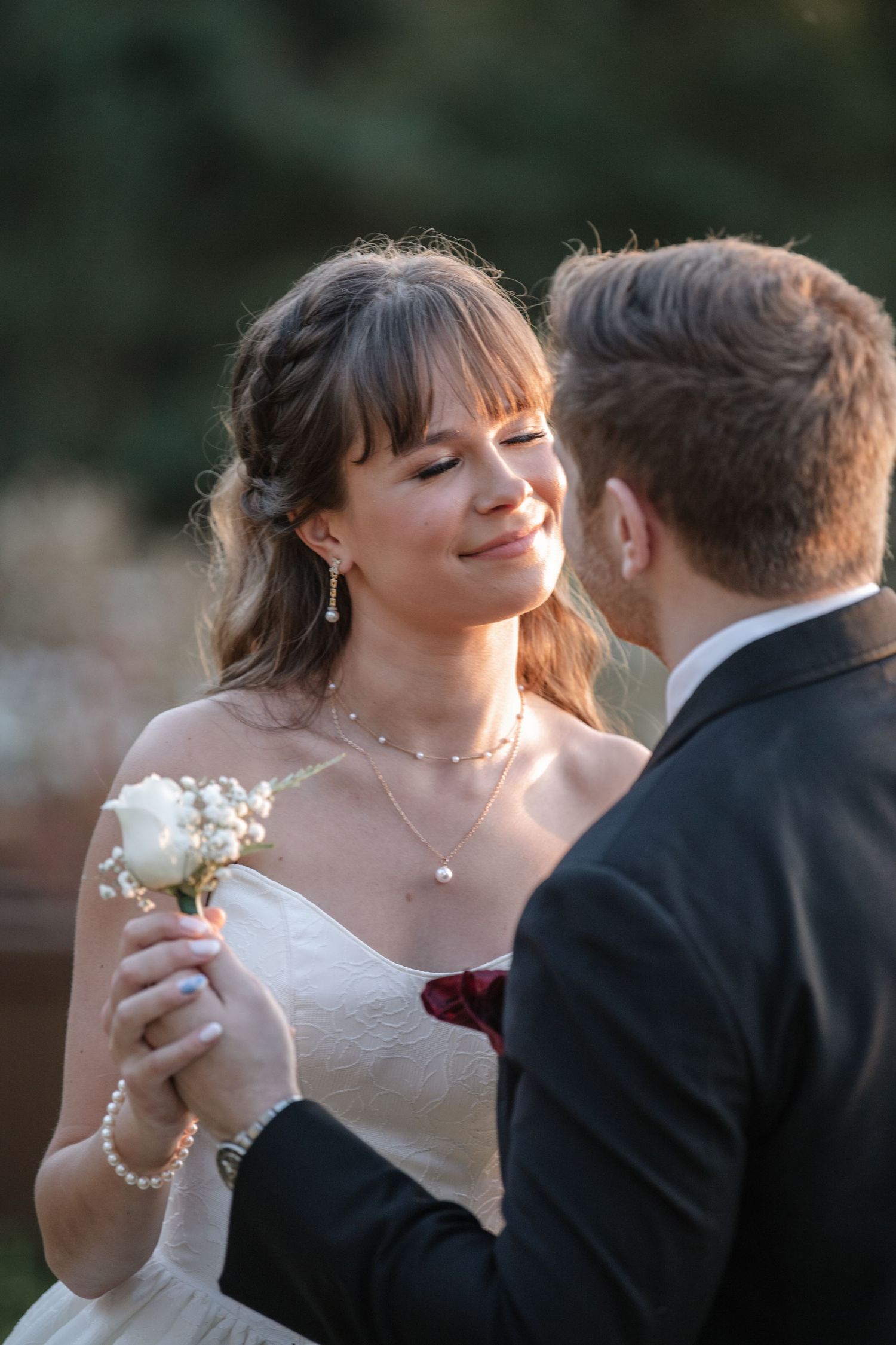 Intimate close-up of a tender moment between newlyweds during their wedding portraits.