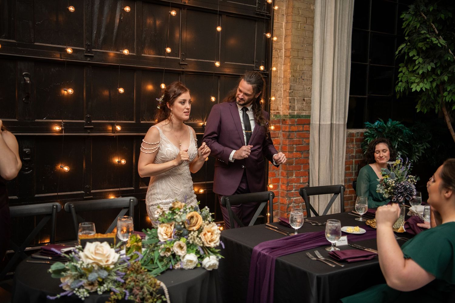 Wedding reception dinner with string lights and floral decorations creating a warm ambiance.