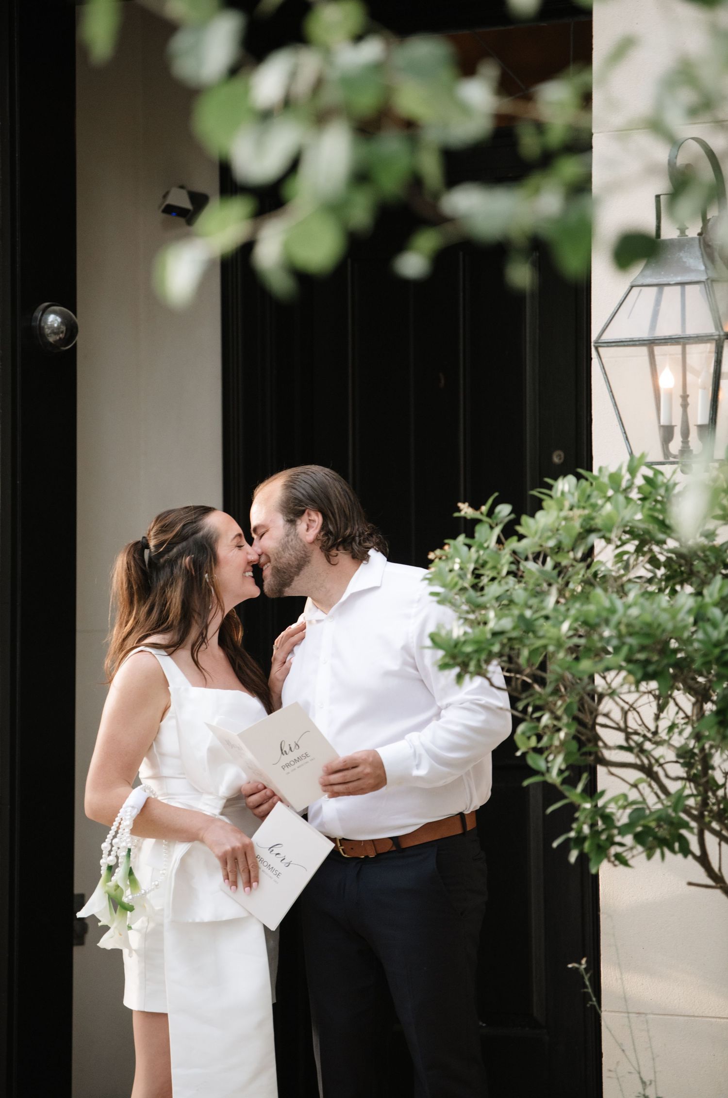 A series of romantic wedding photos showing tender moments between a couple in a white dress and suit against a garden backdrop.