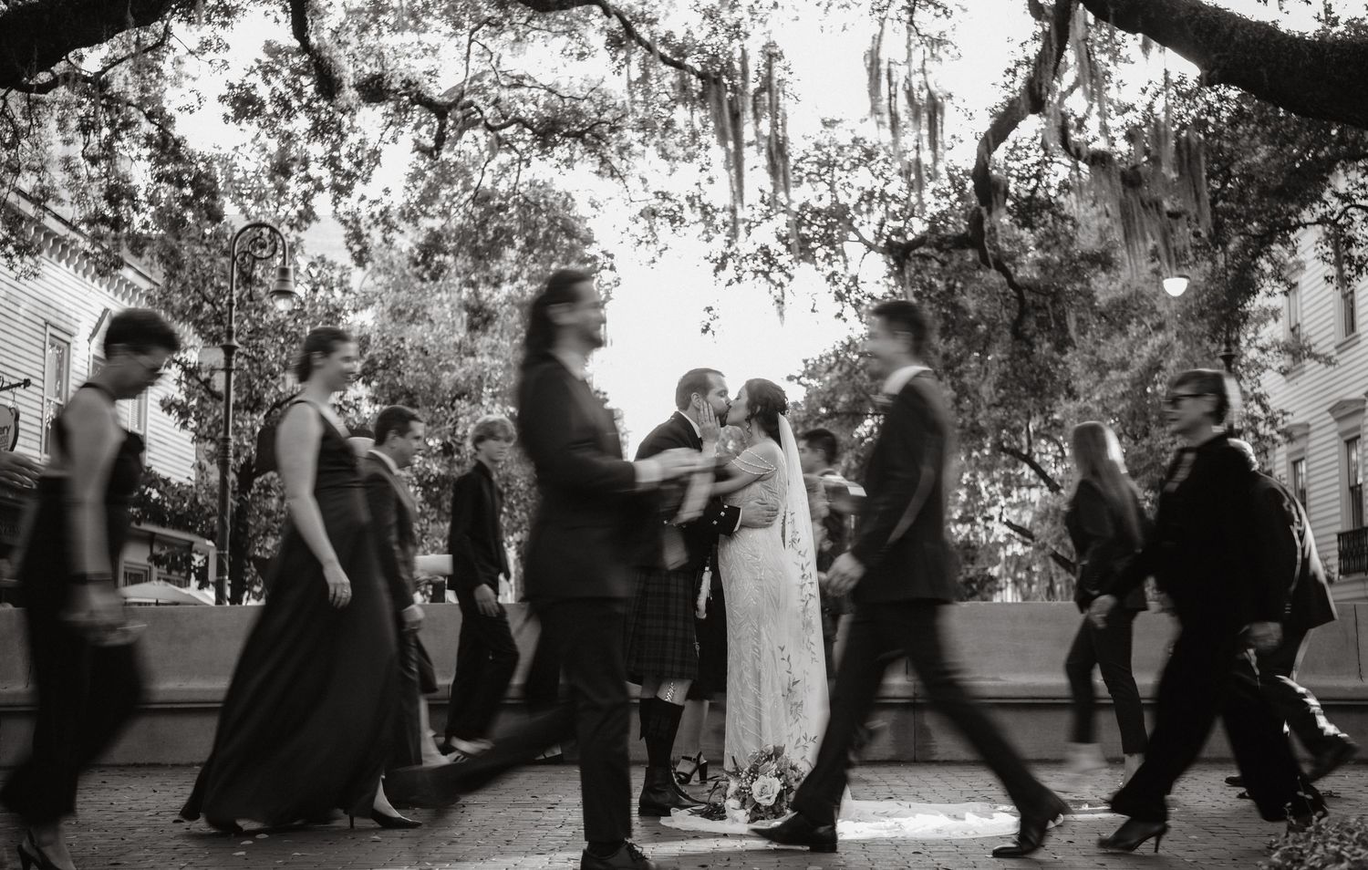 Motion-blurred silhouettes of people dancing at an outdoor event.