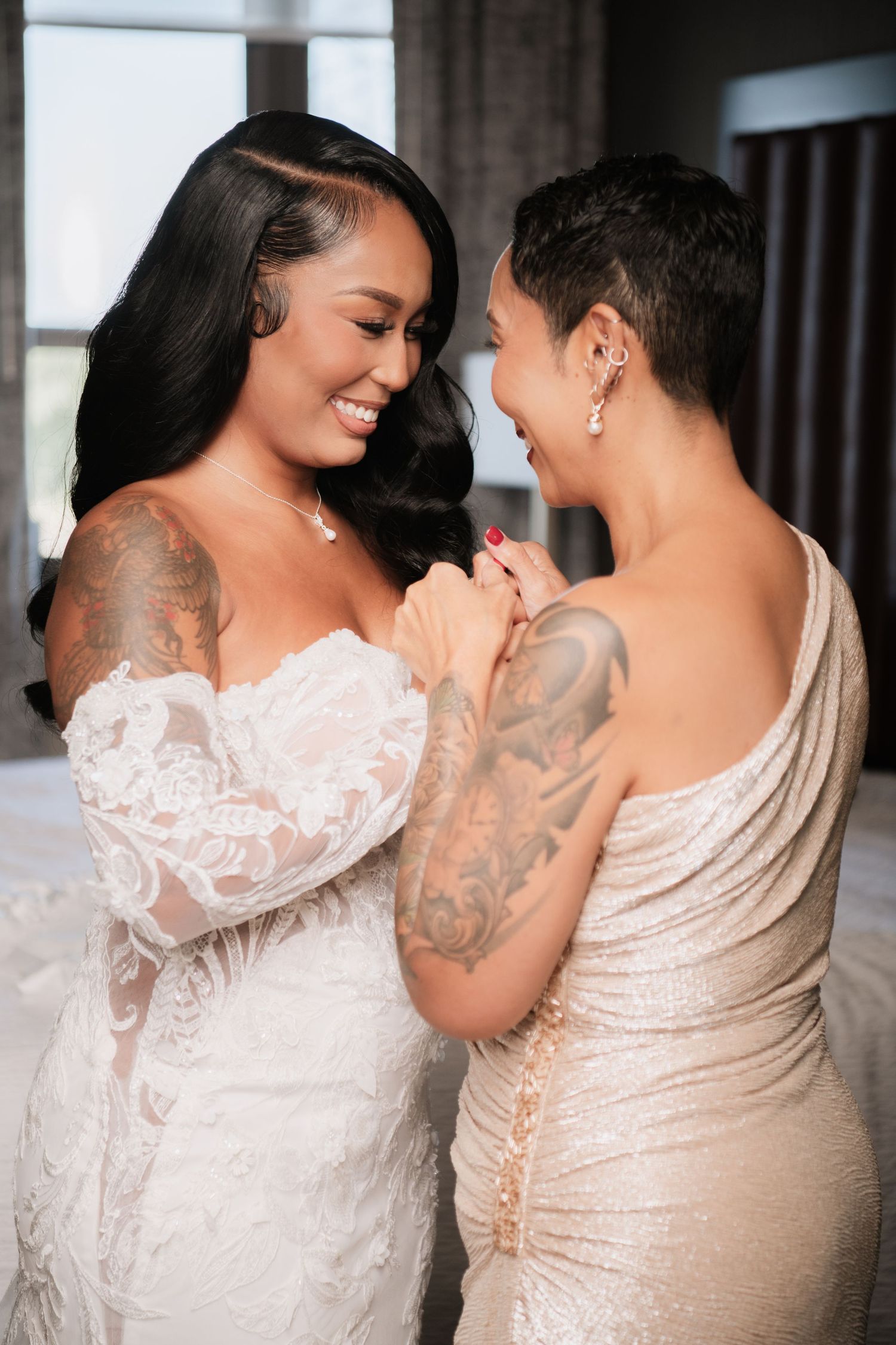 A tender moment captured between two people in elegant wedding attire.