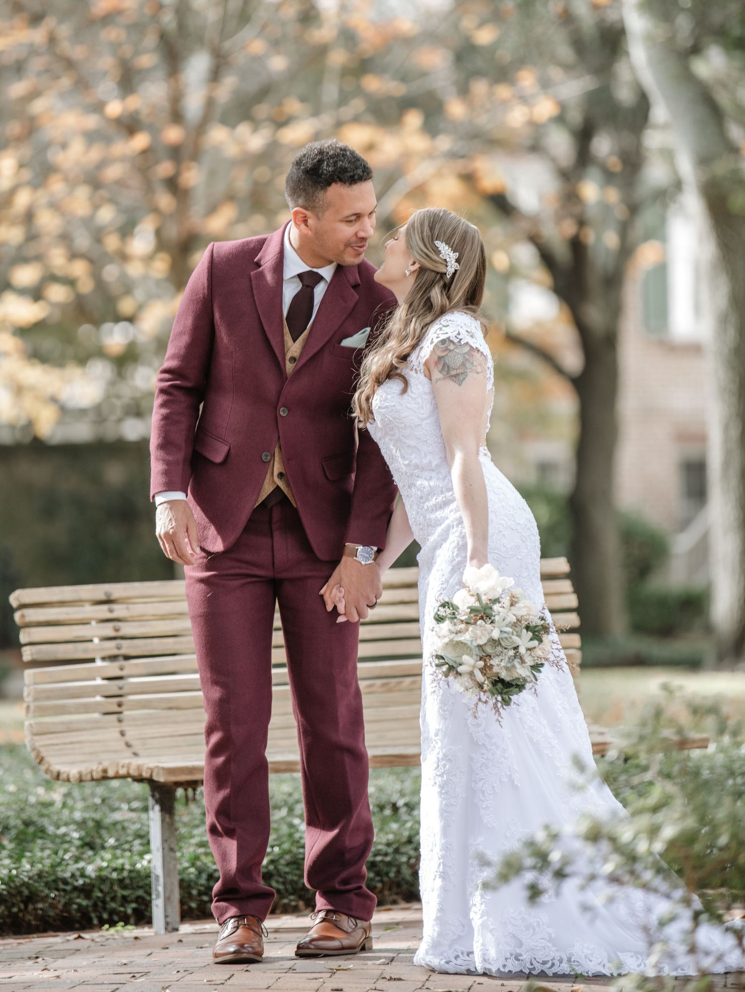 A romantic wedding photo series showing tender moments between newlyweds in burgundy and white.