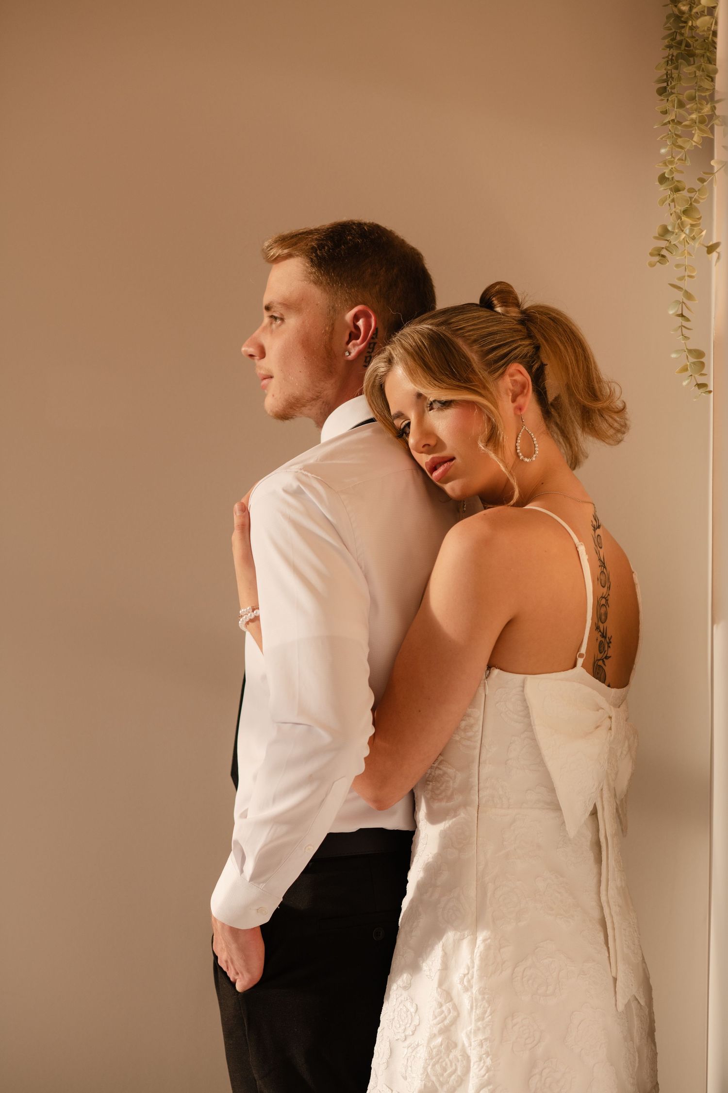 Intimate first look moment between couple in white wedding attire.