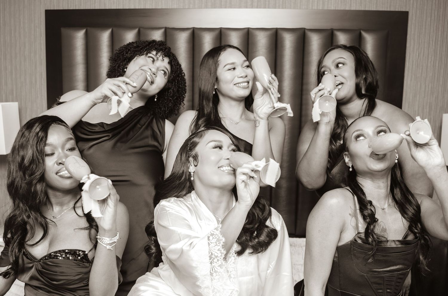 Candid moments of bridesmaids laughing and having fun during wedding day preparations.
