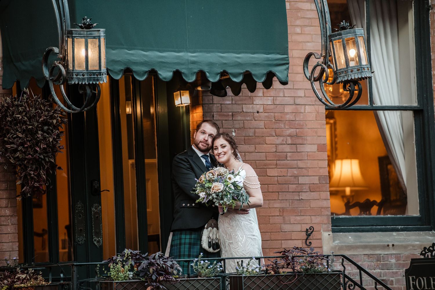Series of romantic moments captured at the entrance of a historic brick building.