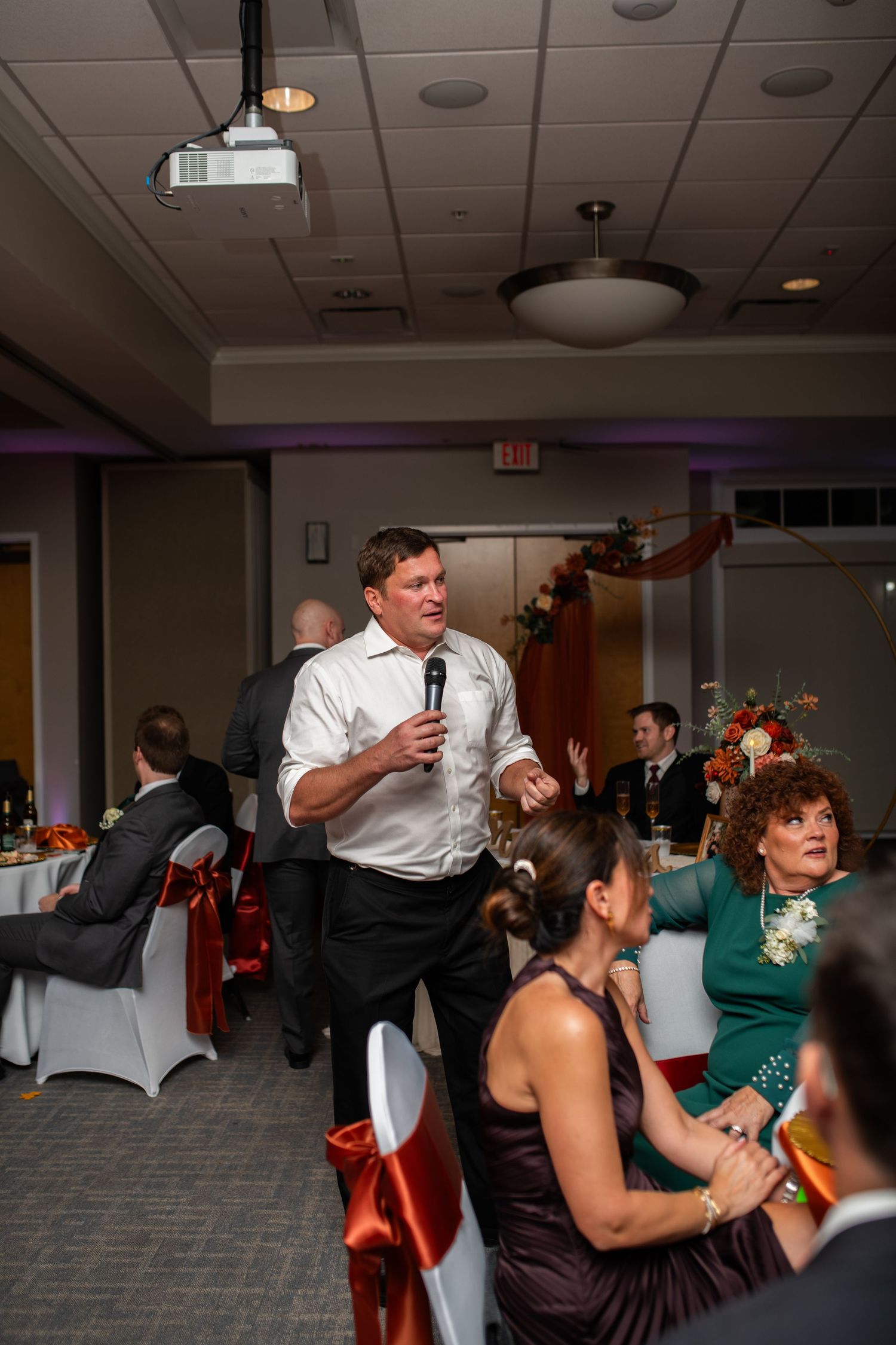Wedding reception guests dancing and celebrating on the dance floor.