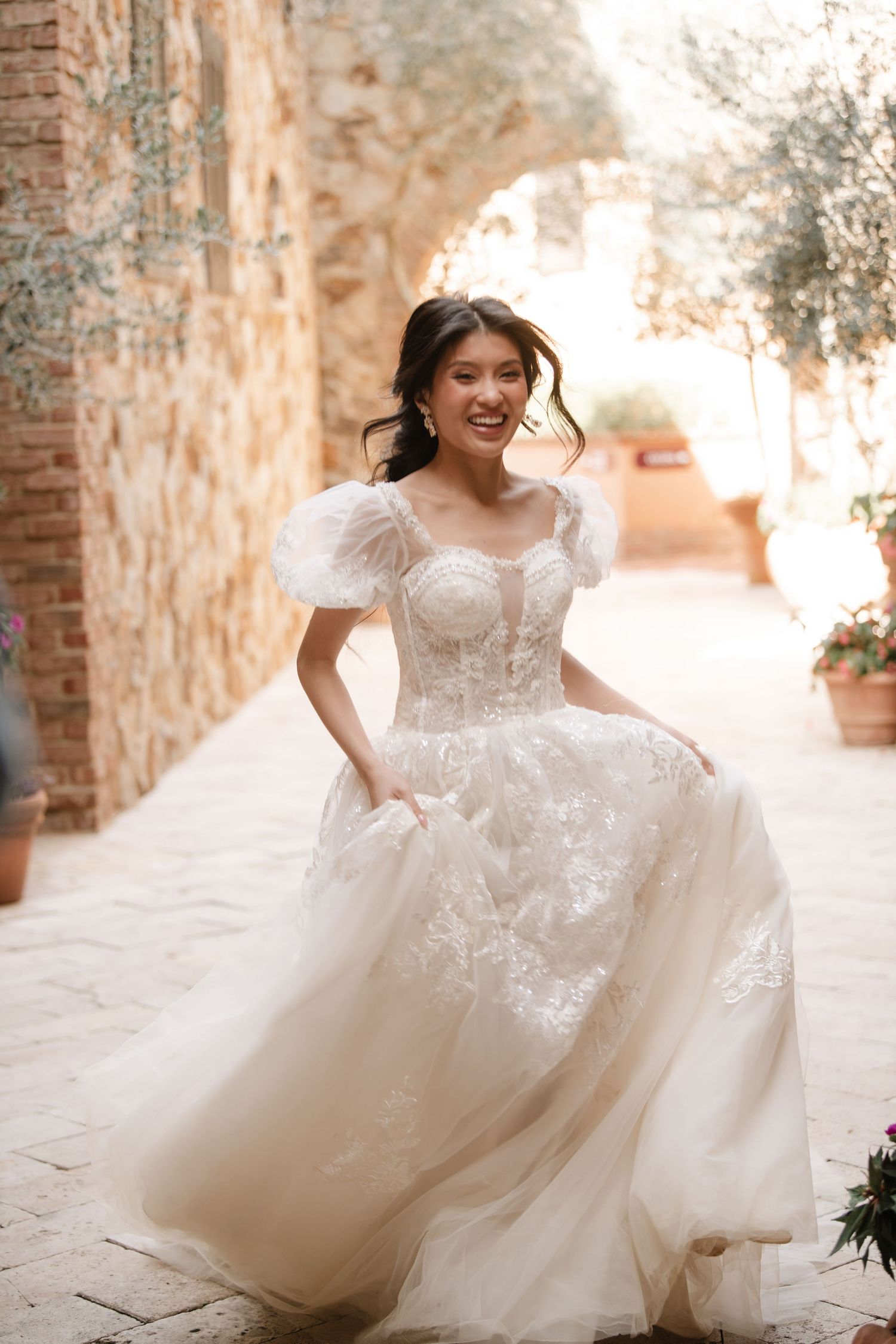 Ethereal bridal portraits showing movement of a flowing white lace wedding gown.