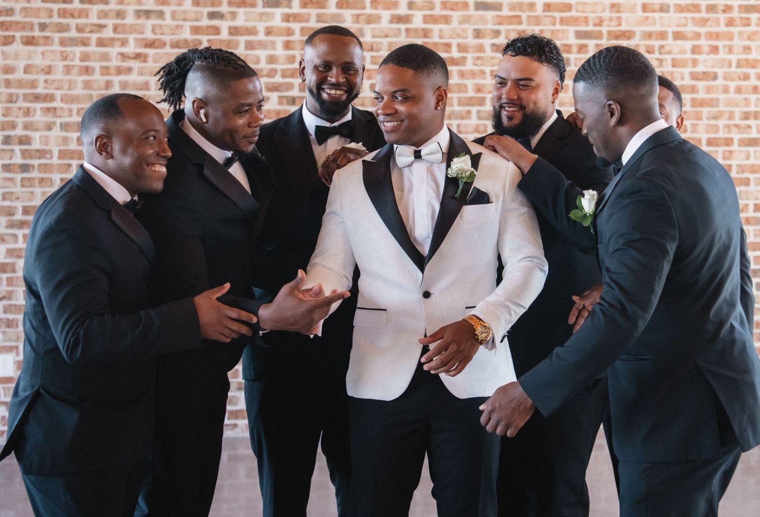 Wedding party in formal attire shares laughs and candid moments together.