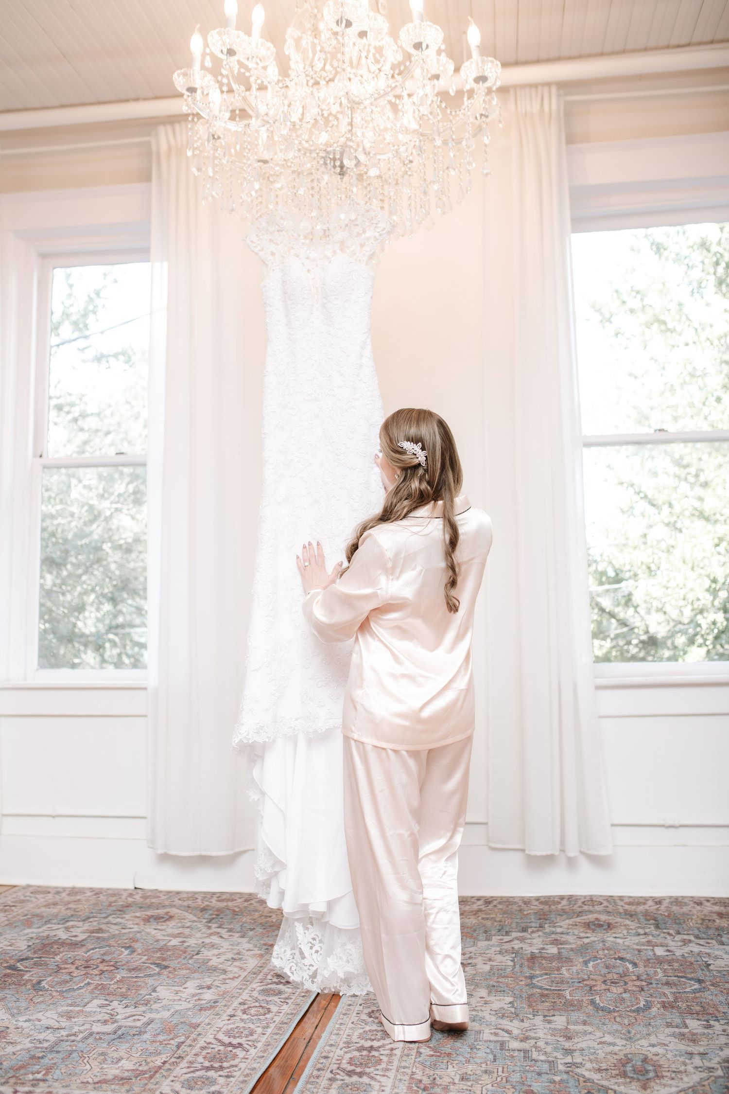 Bright interior space with crystal chandelier and patterned carpet in wedding venue.