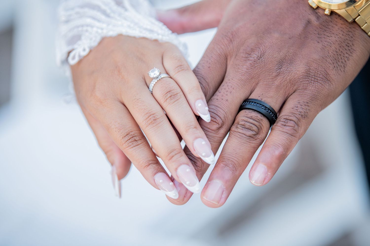 Detailed shots of wedding rings and hands showing both traditional and modern wedding bands.