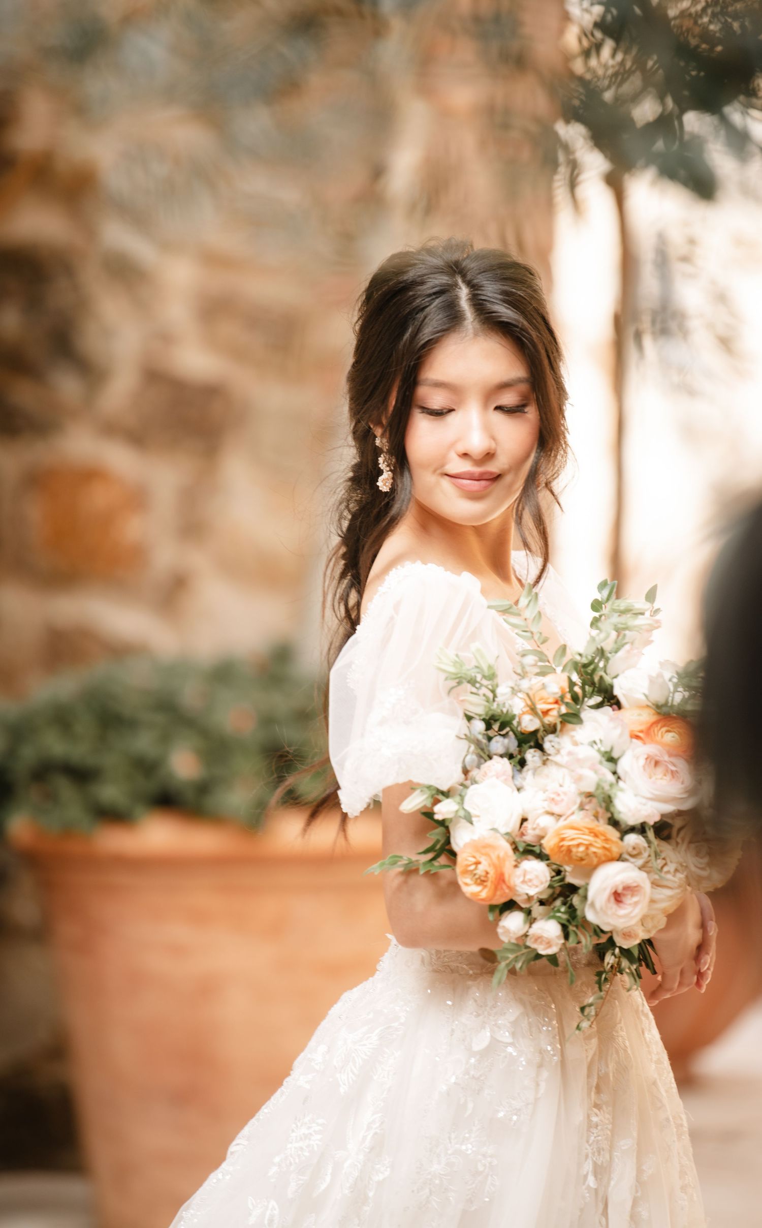 Ethereal bridal portrait with soft-focused florals and delicate lace details.