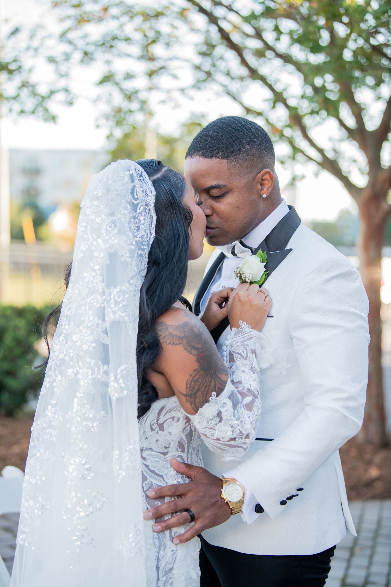 Intimate wedding photography sequence capturing tender moments between newlyweds in an outdoor setting.