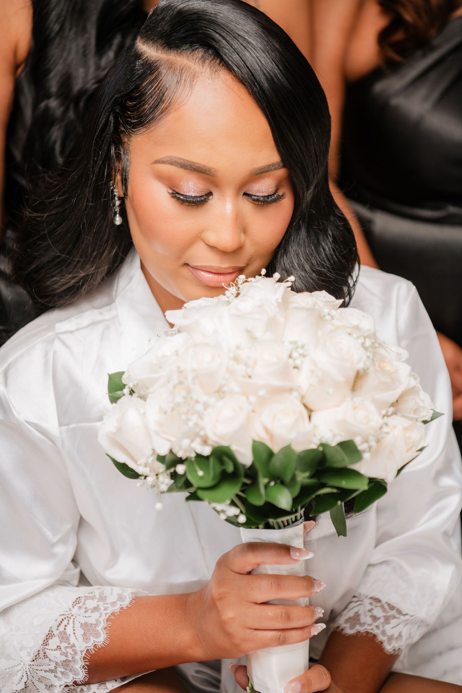 Elegant bridal portrait with white peony bouquet and lace-detailed robe.