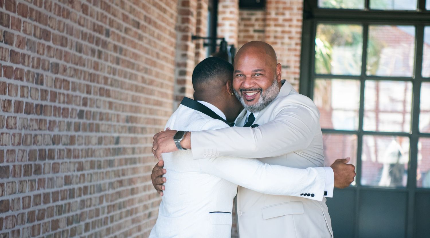 Candid celebration moments captured in a rustic brick-walled venue.