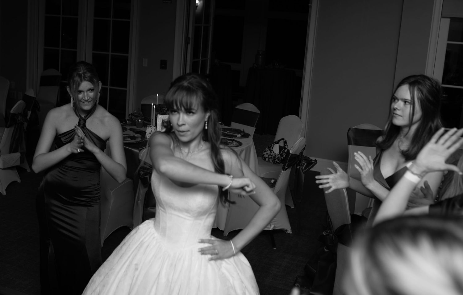 Wedding guests dance and celebrate on the dance floor during the reception.