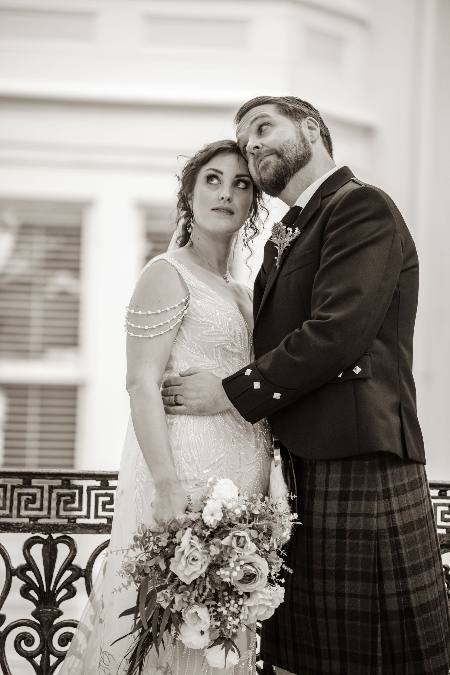 Black and white wedding portraits showing tender moments between bride and groom.