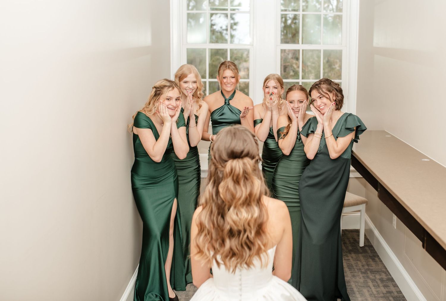 Wedding party photos showing bridesmaids and the bride posing together in a bright indoor space.