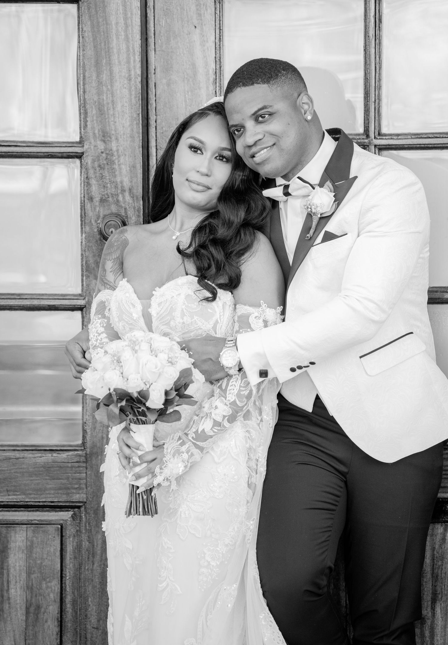 Classic black and white wedding portraits capturing intimate moments between couple.
