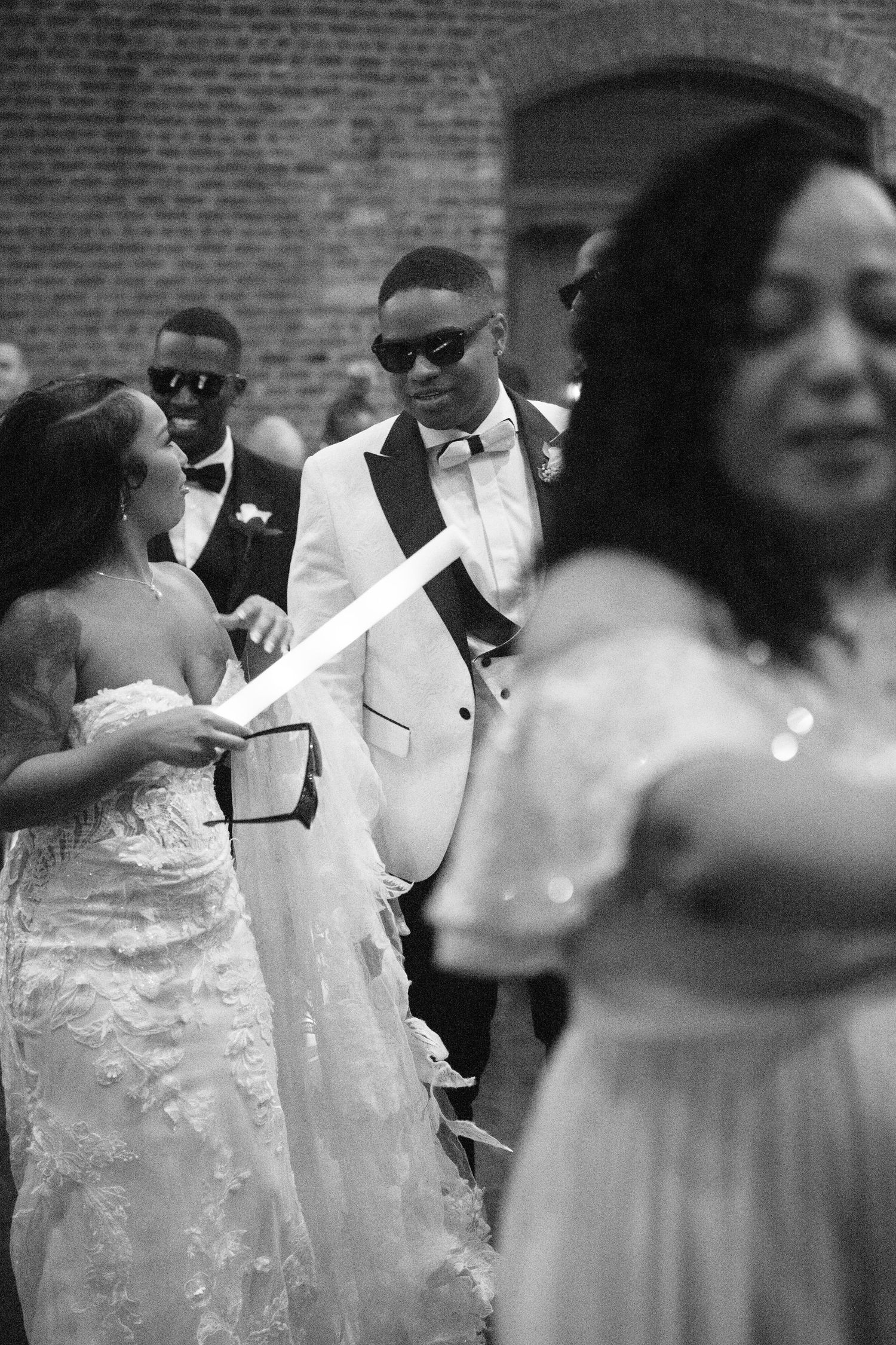 Wedding guests dancing and celebrating in elegant formal wear.