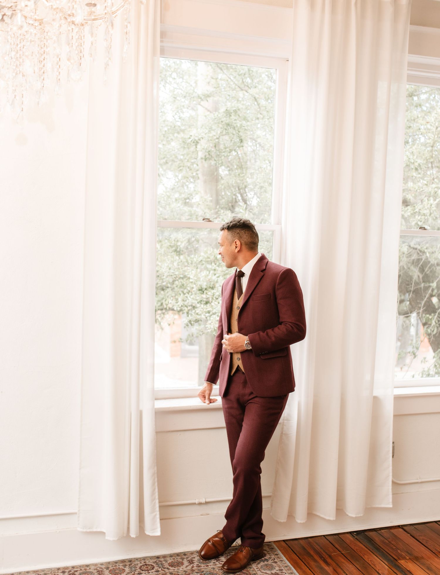 Light-filled room with white curtains and elegant window frames.