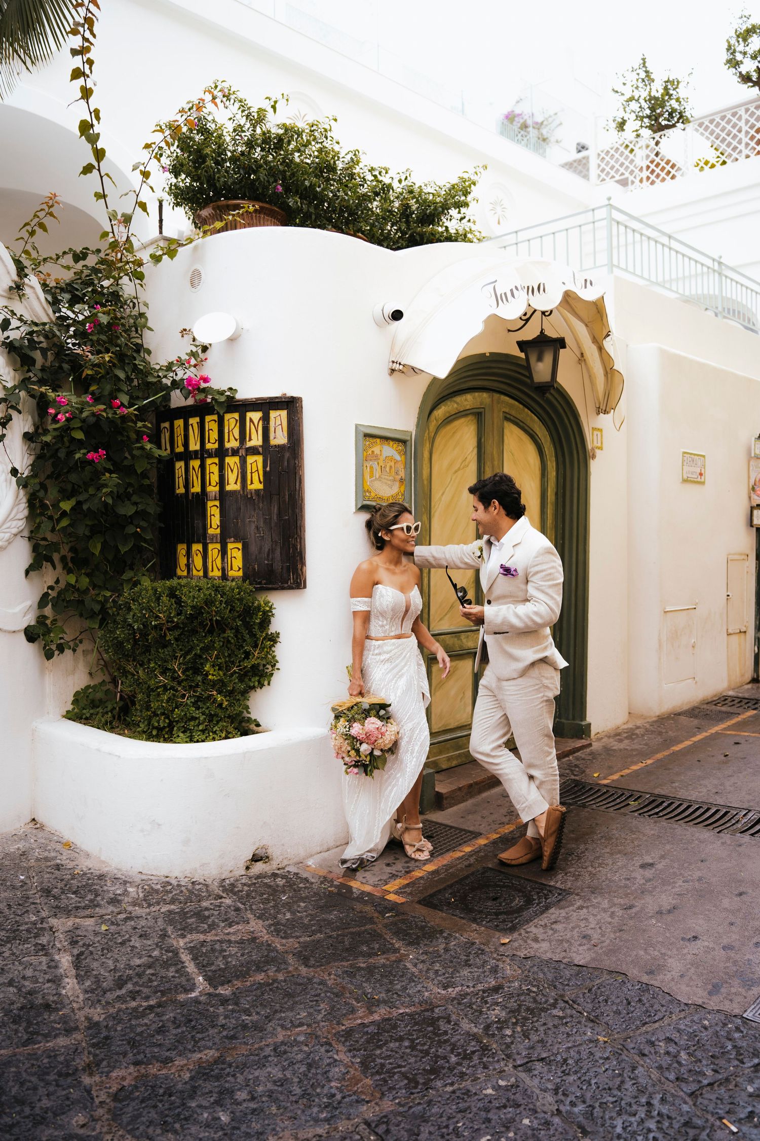 A Mediterranean-style courtyard with white stucco walls and arched doorways shown in a sequence of romantic moments.