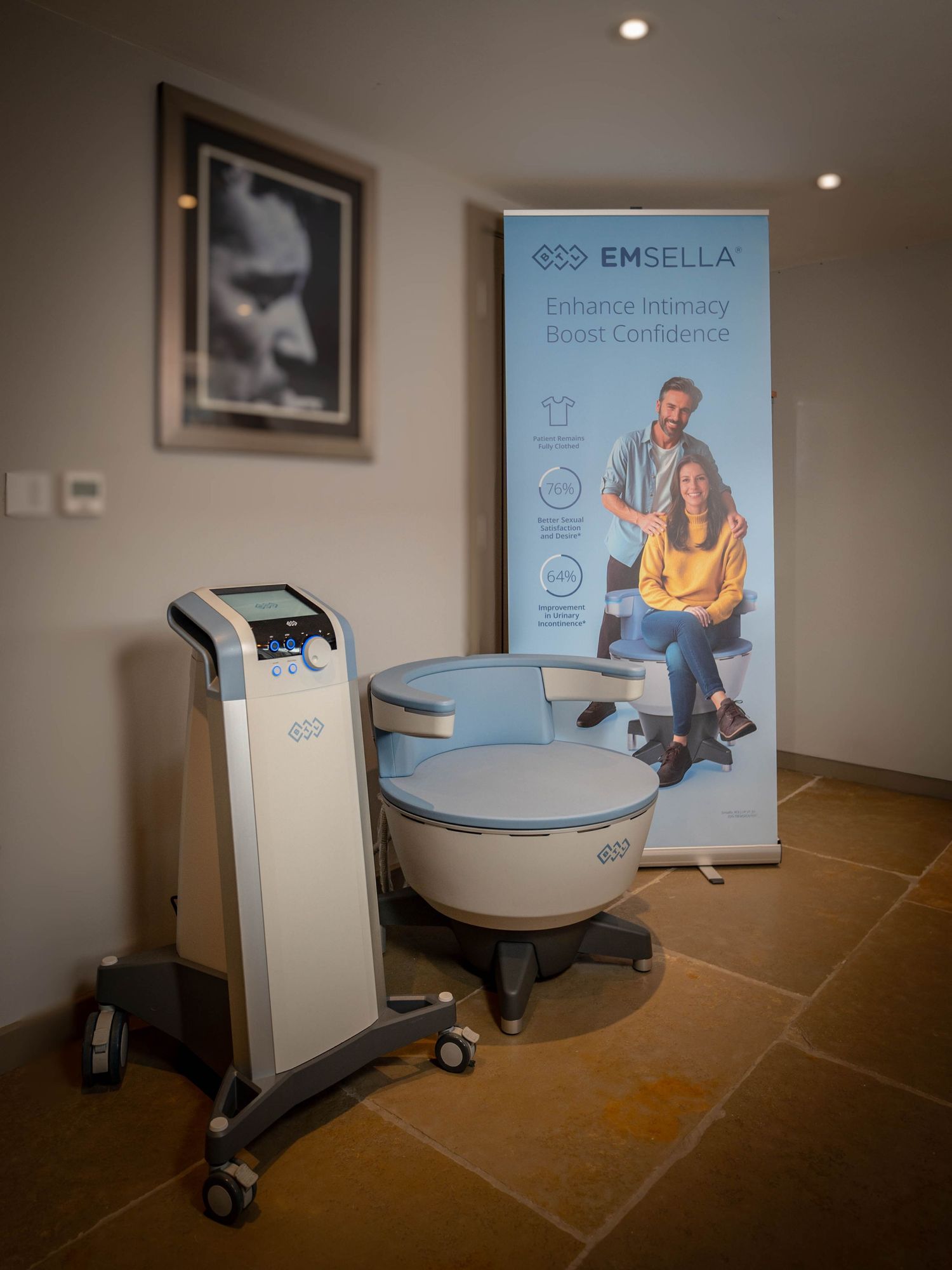A series of medical treatment chairs and equipment shown in a modern healthcare facility with blue signage displays.