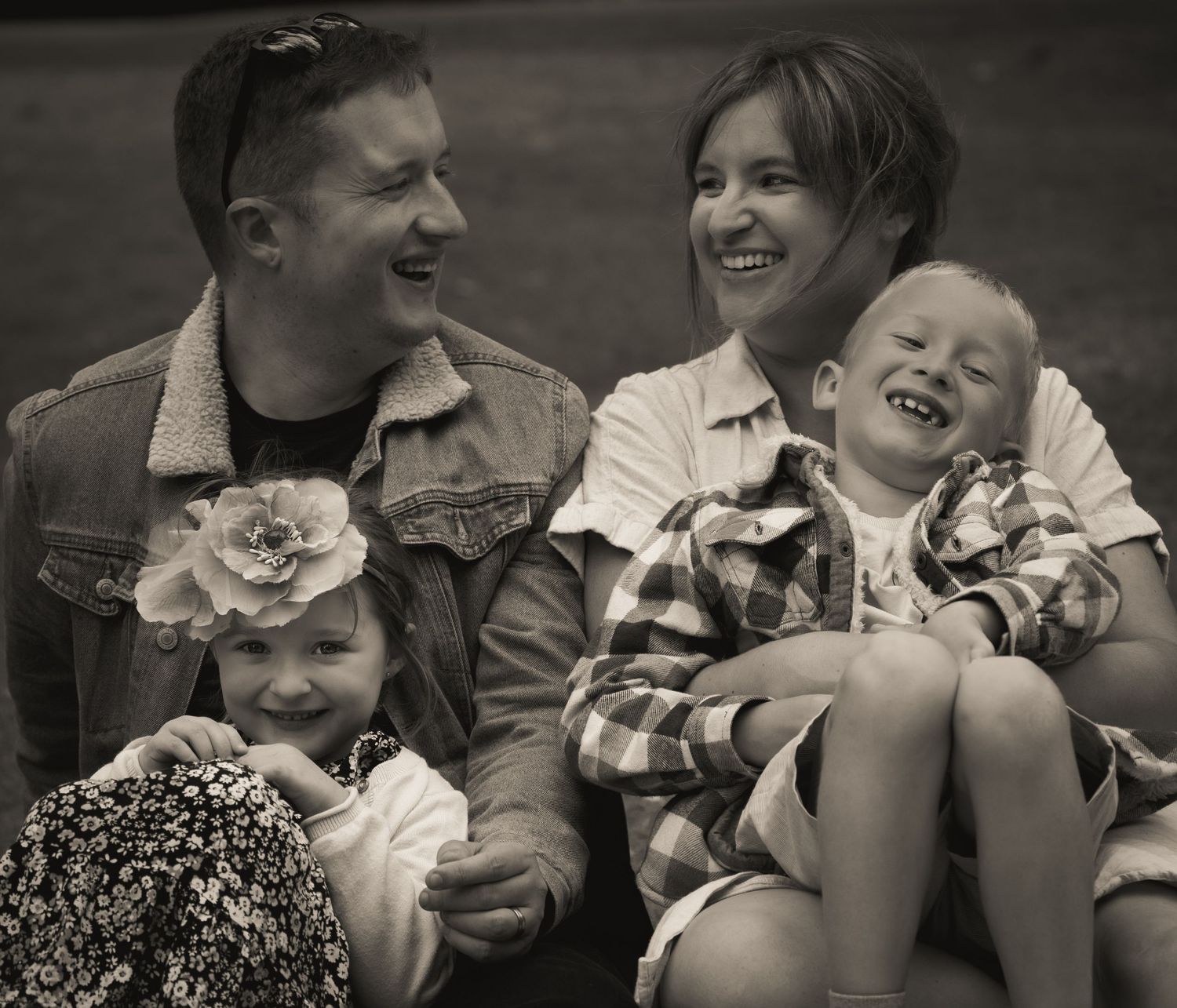 Series of candid black and white shots showing joyful family interaction.