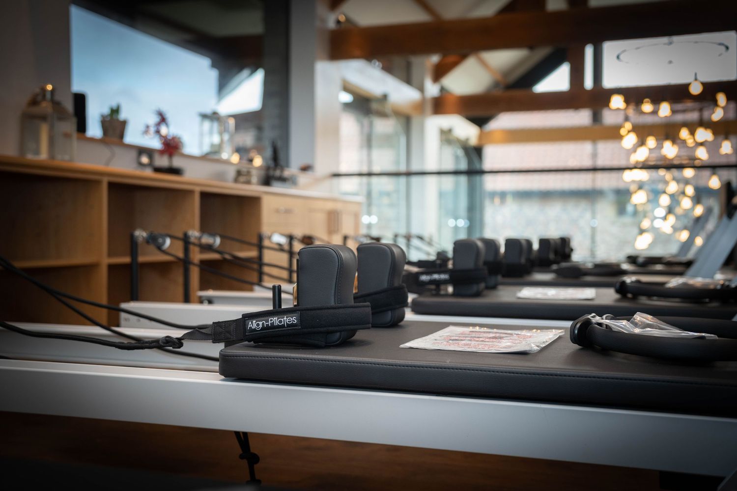 Architectural model display shows modern building designs on a sleek table in a well-lit studio space.