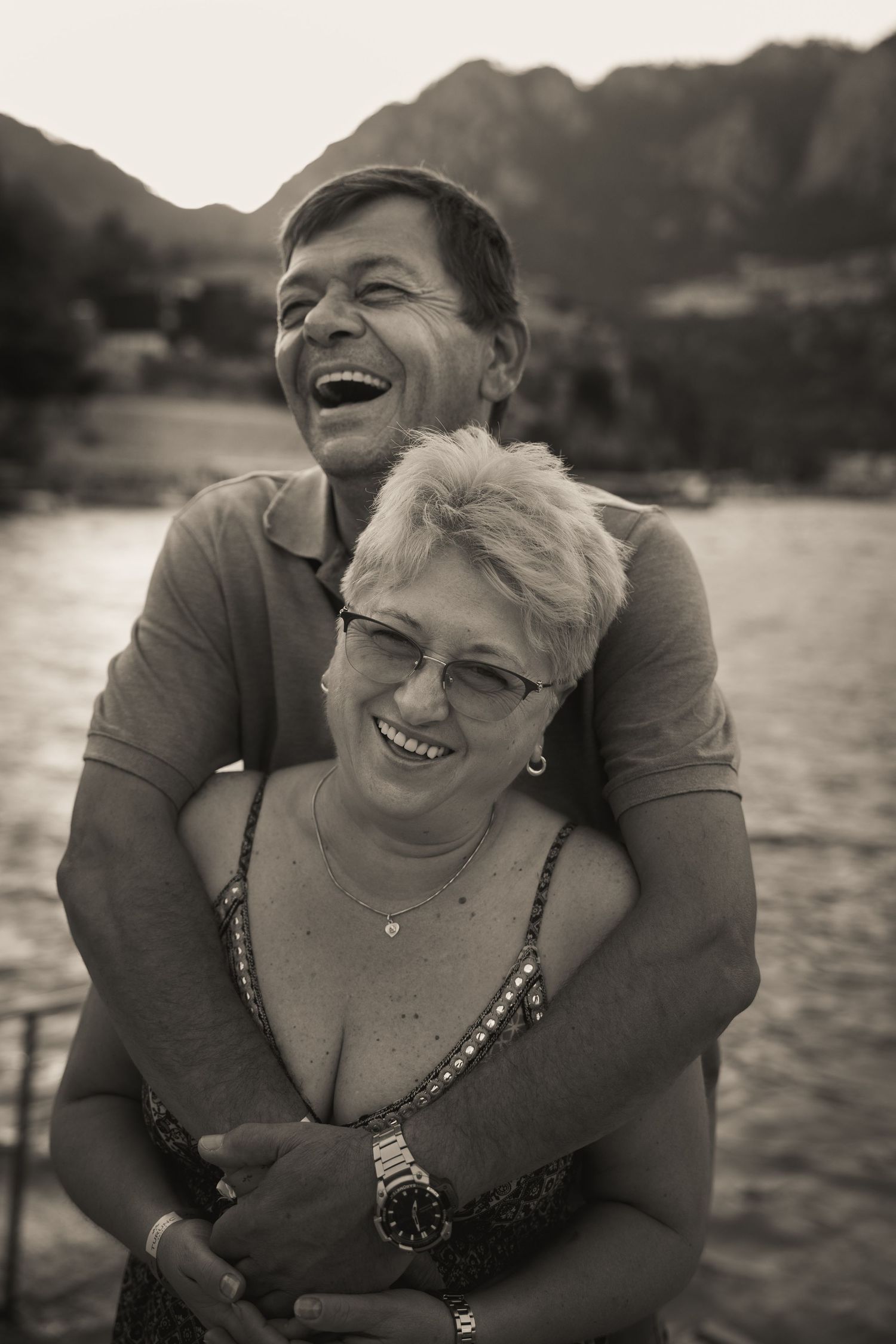 Couple sharing joyful moments together by the lake.