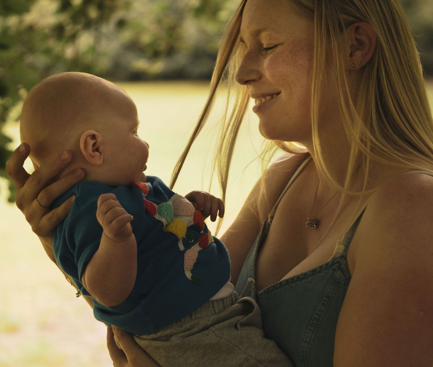 Warm-toned candid family moments captured in golden sunlight.