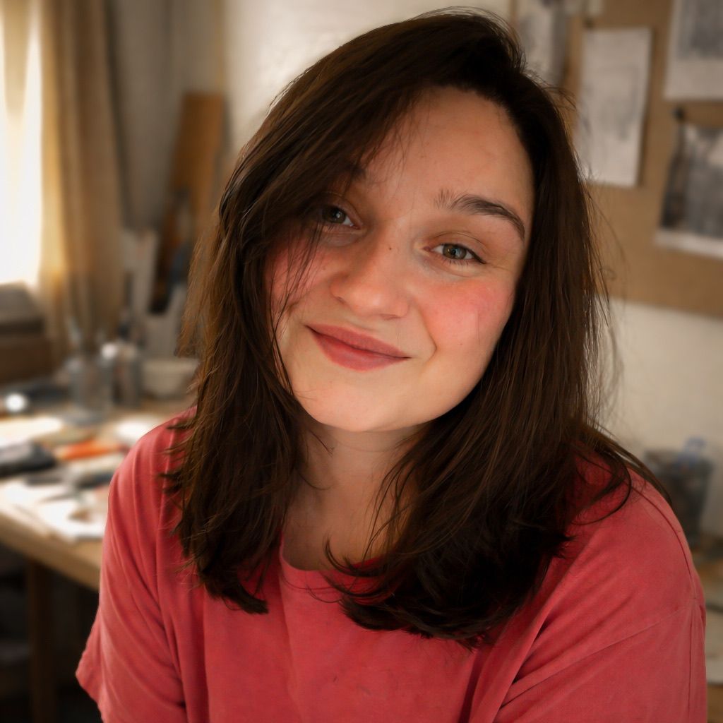 Person with dark hair and rosy cheeks smiling warmly at camera in four sequential portrait shots.