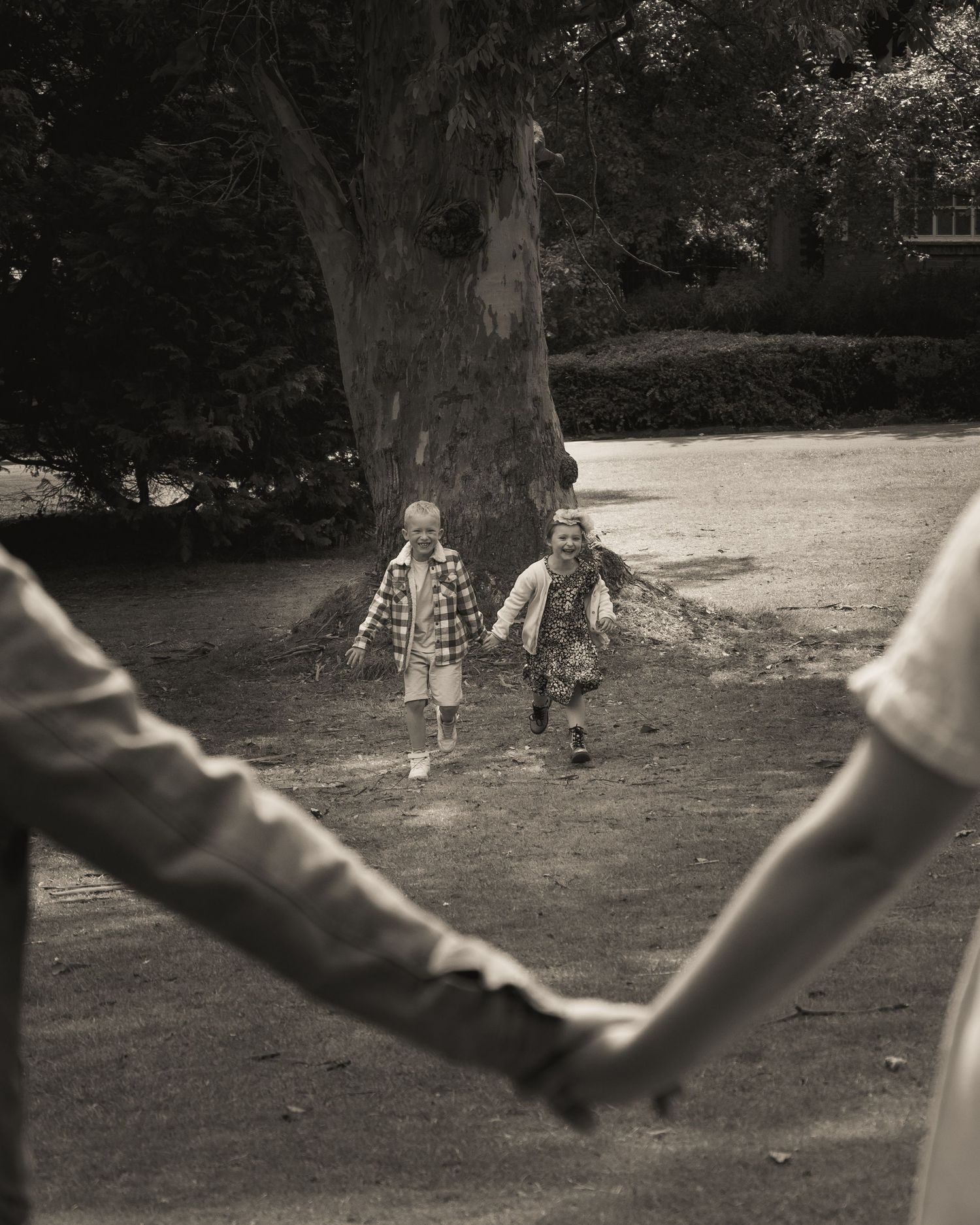 Black and white sequence showing children playing in a park setting.