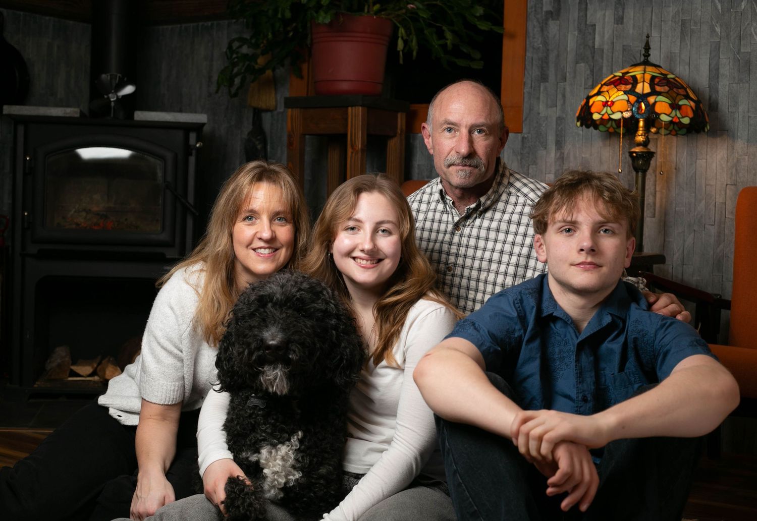 Family members pose together in a series of candid black and white portraits showing warmth and connection.