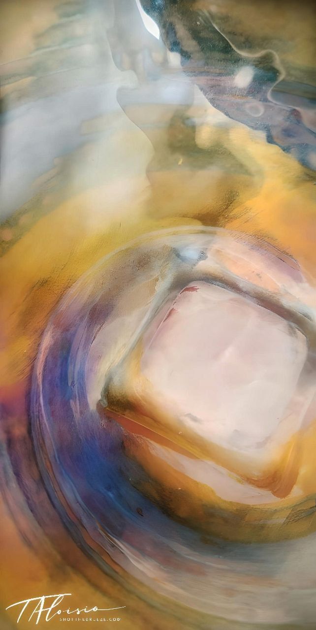 Abstract fluid art photography with swirling pastel colors in motion.