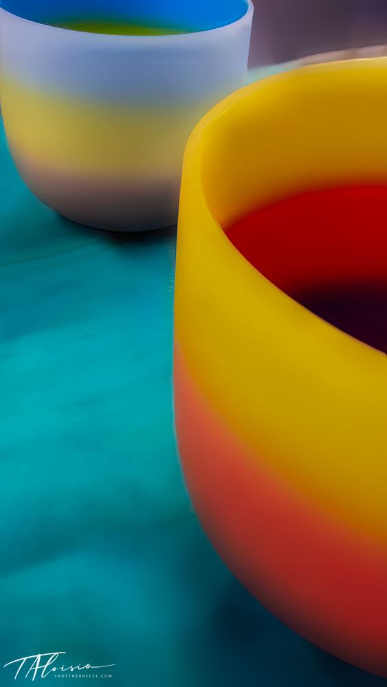 Abstract curved shapes in yellow, red and blue creating a colorful minimalist composition.