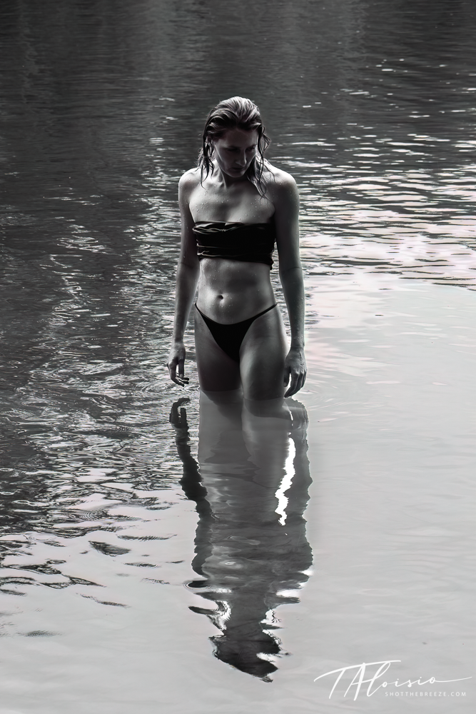 Artistic black and white sequence of a figure wading through reflective water.