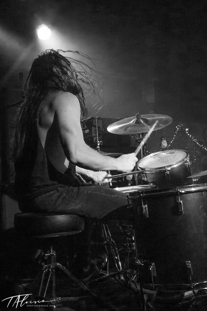Dramatic black and white sequence of a drummer performing with hair in motion.