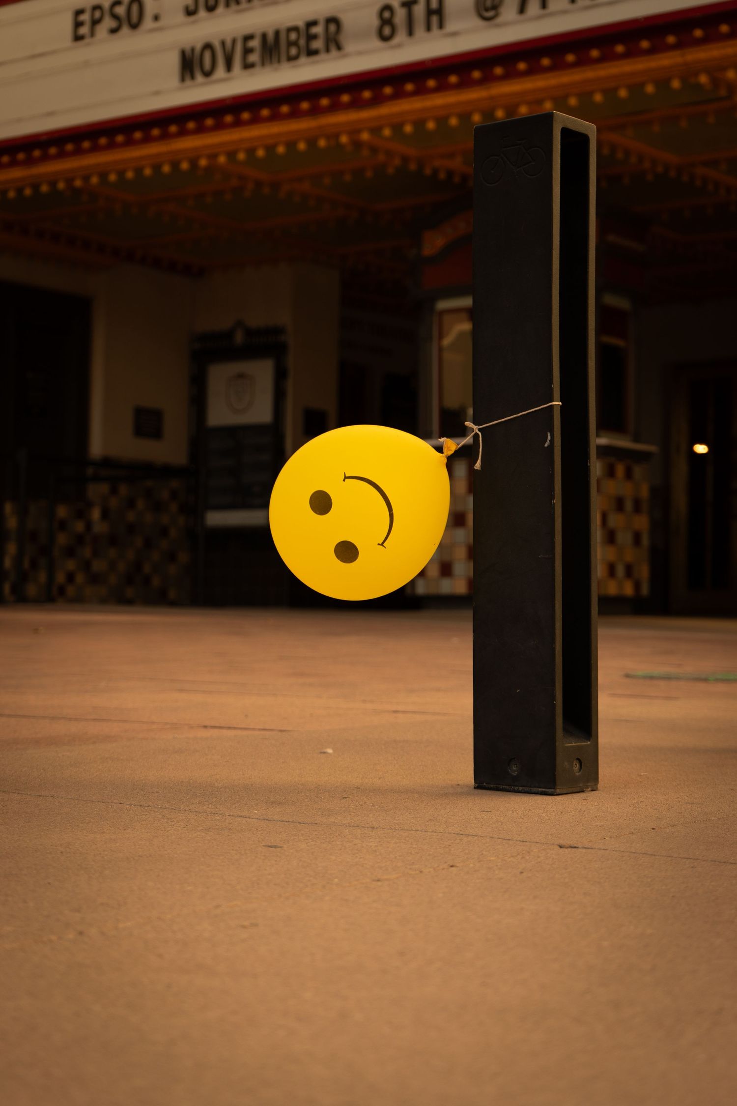 A close-up view of yellow bowling lane markers on a polished wooden floor at a bowling alley.