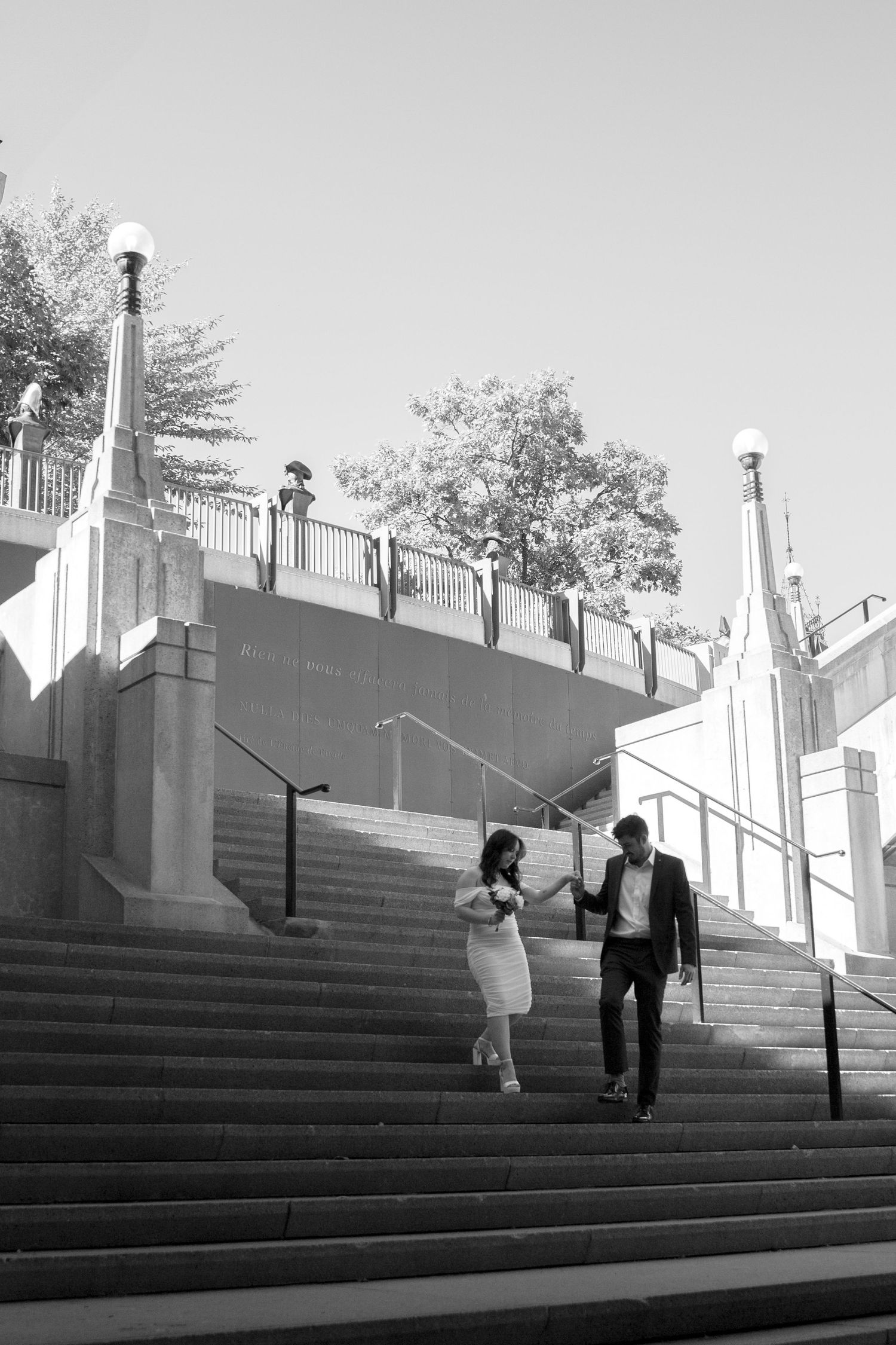 Black and white photo sequence showing a couple walking down grand stone steps at a historic building.